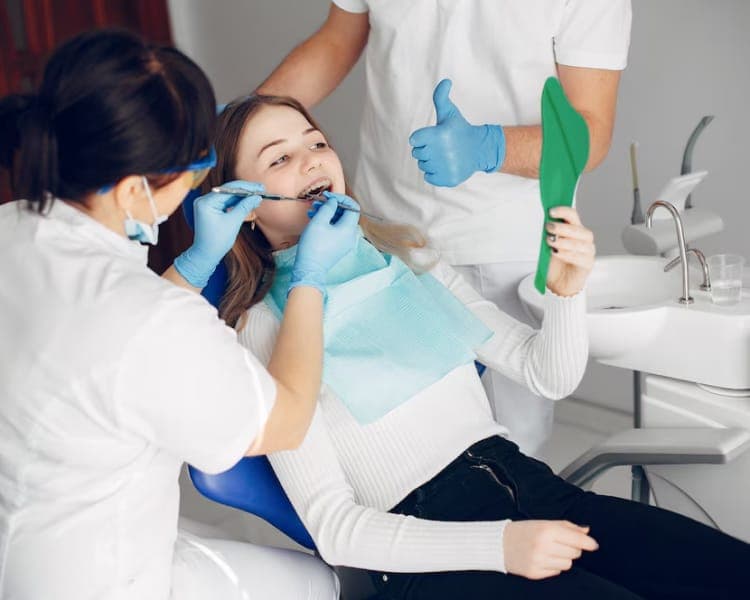 Hygienist cleaning a patient’s teeth