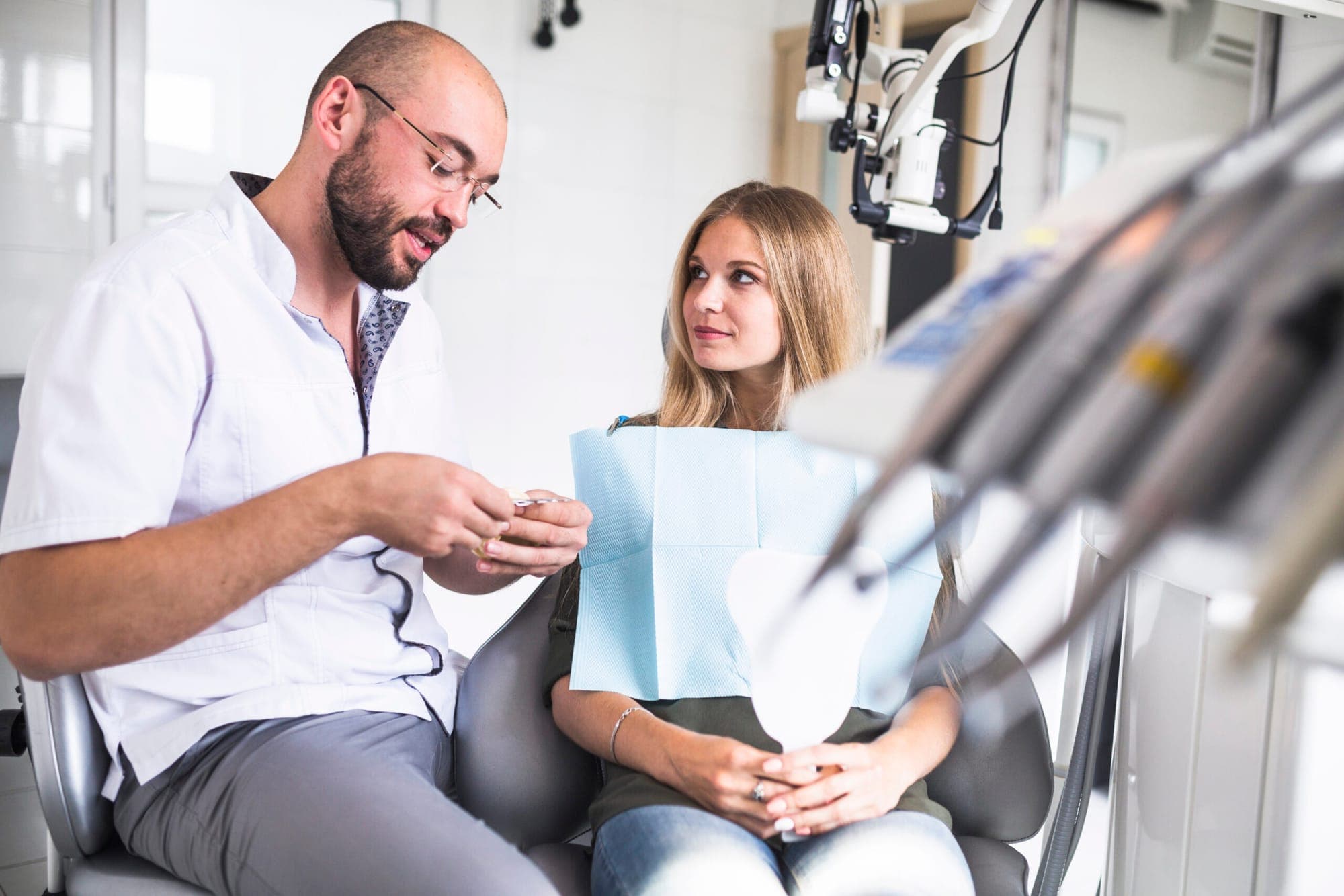 Dentist talking with a patient during a mouth cancer screening