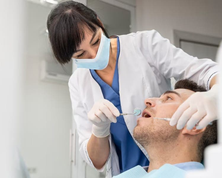Dentist explaining tooth brushing to a patient