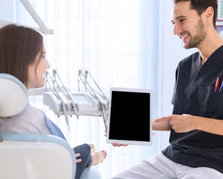 Patient at reception asking about help with NHS dental costs