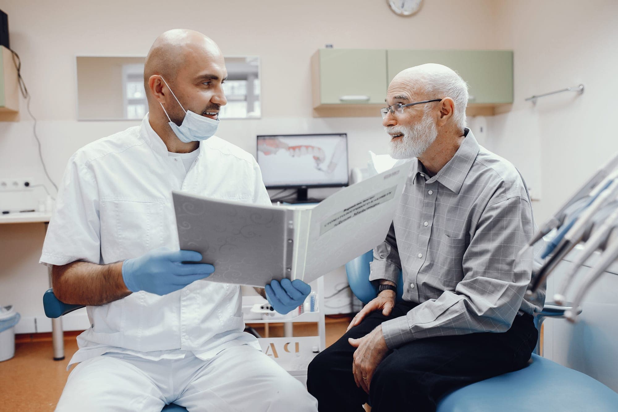Dentist going through a treatment plan with an older patient